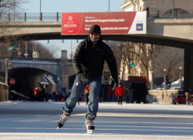 FILE PHOTO: A man skates on the Rideau Canal Skateway, the world's largest skating rink, during a period of subzero Arctic weather in Ottawa