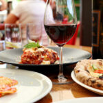 Glass,of,red,wine,with,lasagne,,pizza,and,ravioli