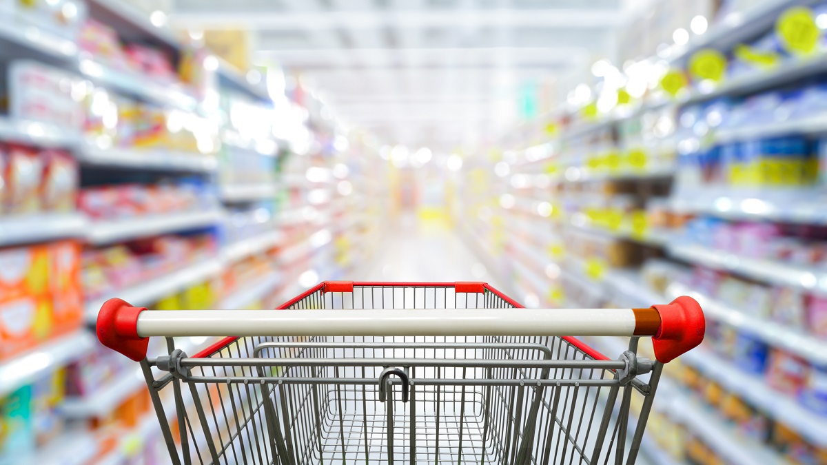 Supermarket,aisle,with,empty,red,shopping,cart.